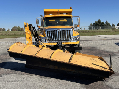 Front view of a yellow 2016 International WorkStar 7600 plow truck with large snow plow attachment, cab in center, chrome grille, and side mirrors.