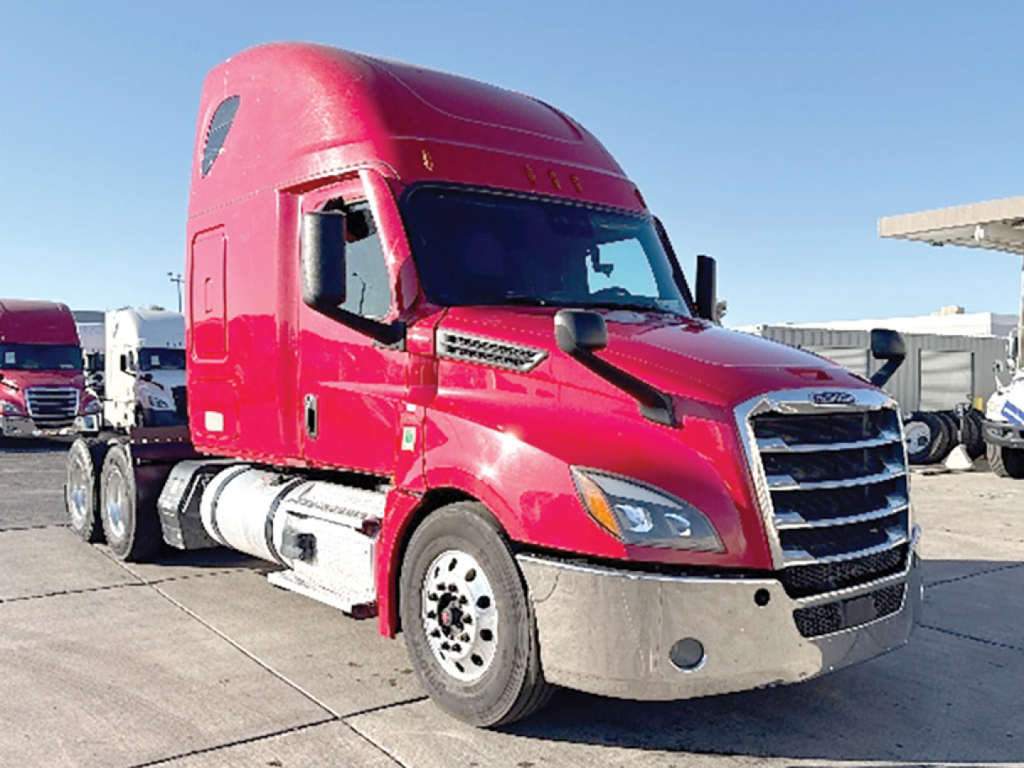 Freightliner Cascadia 126 tractor in magenta/red color, front cab view with silver bumper, large grille, and dual fuel tanks on the side.