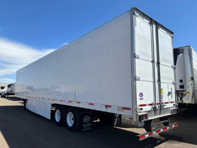 Utility 3000R trailer showing plain side, tandem rear axles, and closed doors.