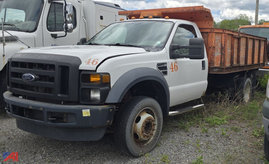 Ford F-450 XL Super Duty dump truck front-left view with orange dump bed and number 46 on door.