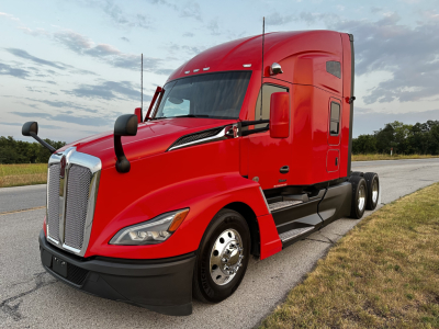 Kenworth T680 semi-truck side-angle view in red with sleeper cab, chrome grille, and black bumper.