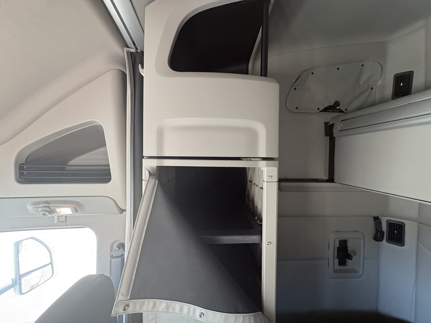 Peterbilt 579 cabin storage compartment with open overhead shelf and interior panels visible