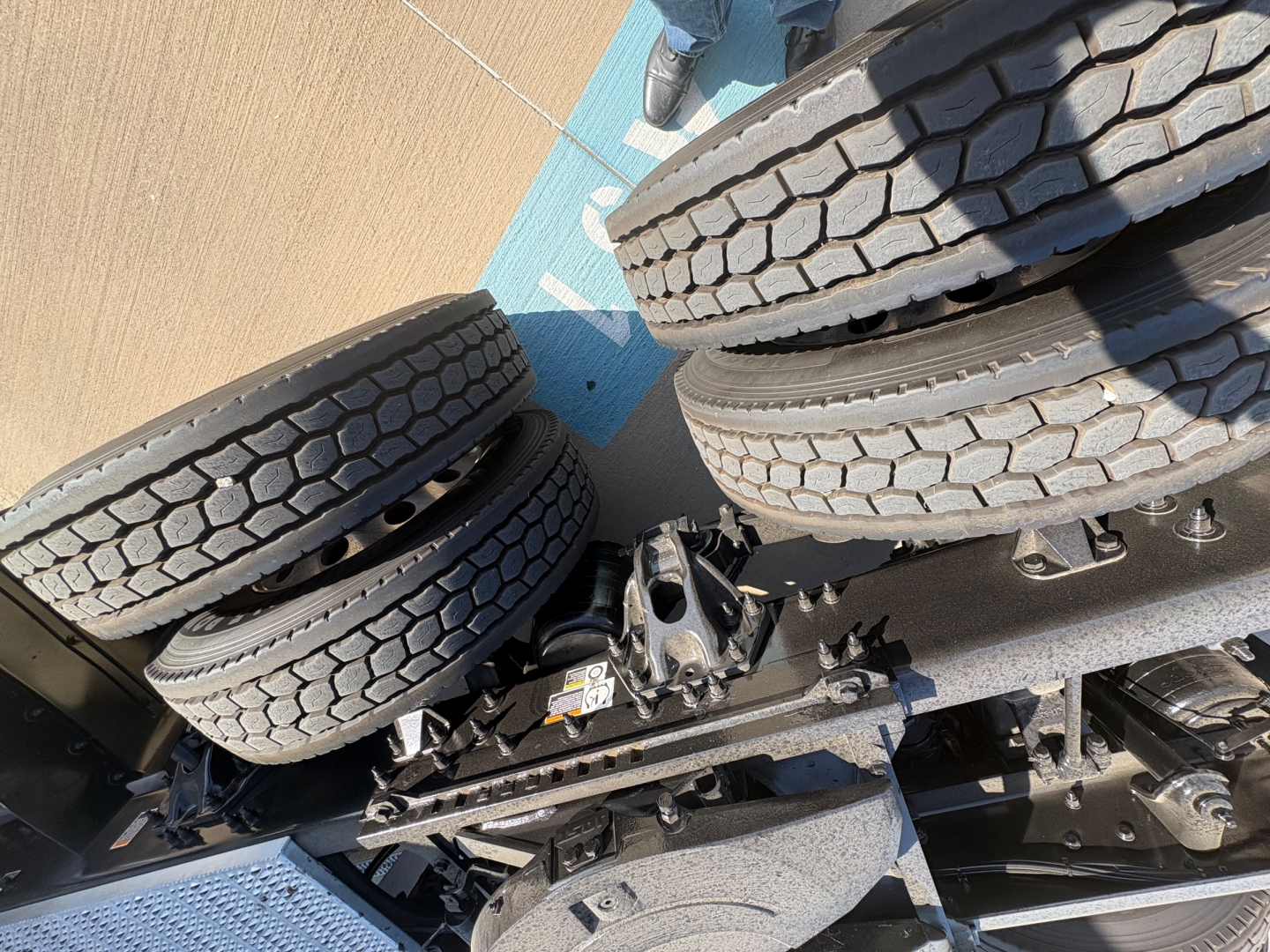 Tires and chassis components of a Peterbilt truck chassis with wheels and suspension visible; no legible text captured.