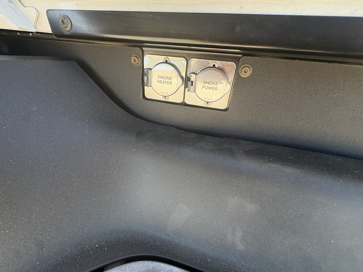 Peterbilt 579 engine bay area showing push-to-connect switches labeled Engine Heater and Shore Power.
