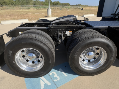 Peterbilt 579 tractor chassis showing dual rear axles and chrome wheels with tires in view.