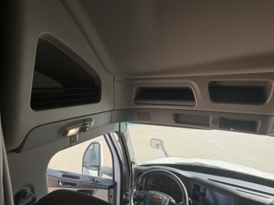 Peterbilt truck interior cabin view with steering wheel, dash, driver seat area.