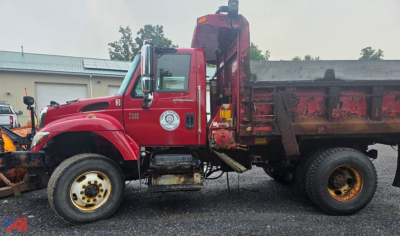 Dump truck side view showing 2006 International WorkStar 7500 with plow and dump bed.