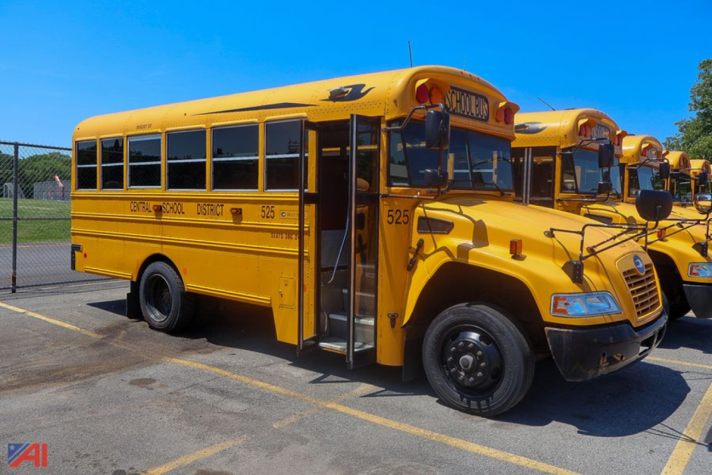 School bus in-service showing side view with open door and yellow body.