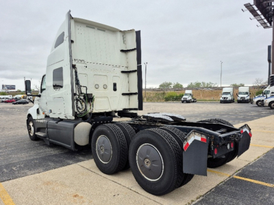 Truck cab and chassis of a 2023 International LT625 semi-truck seen from the rear left side, with three axles and fifth-wheel area visible.