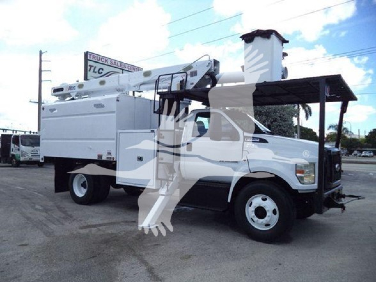 Ford F-750 bucket truck showing bucket lift and utility body with crane, side view full cab and front wheel
