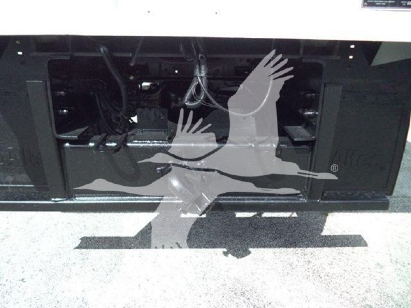 Ford F750 bucket truck front bumper area showing engine bay access and wiring harnesses