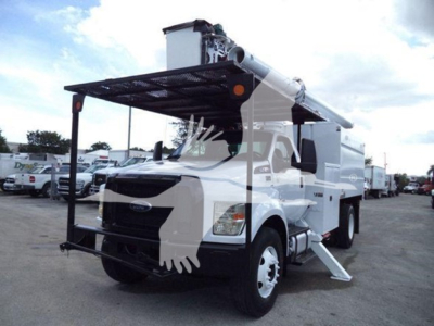 Truck mounted boom lift on 2017 Ford F-750 bucket truck with platform raised, front grille visible, fleet yard in background.