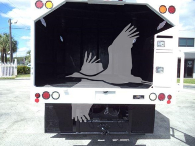 Truck bed open rear view of a 2017 Ford F750 bucket truck showing empty cargo area and towing hitch, license plate not visible.
