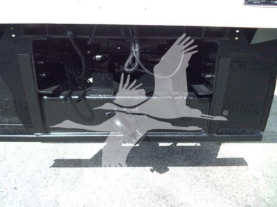 Ford F750 bucket truck front bumper area showing engine bay access and wiring harnesses