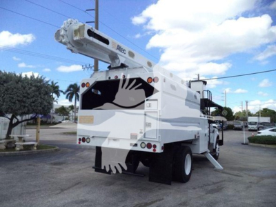 Ford F750 bucket truck rear and crane arm visible, white with black graphic, rear lights, and lifting platform.