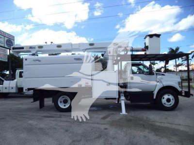 Ford F-750 bucket truck side view showing utility body and boom lift with stabilizers extended.