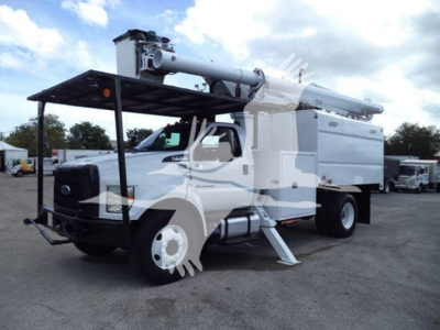 Bucket truck mounted on a 2017 Ford F-750 with utility body and extending crane, front bumper guard, and stabilizing outriggers visible.