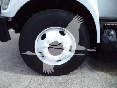 Front wheel of a 2017 Ford F750 bucket truck showing wheel, tire, and part of white body inservice condition.