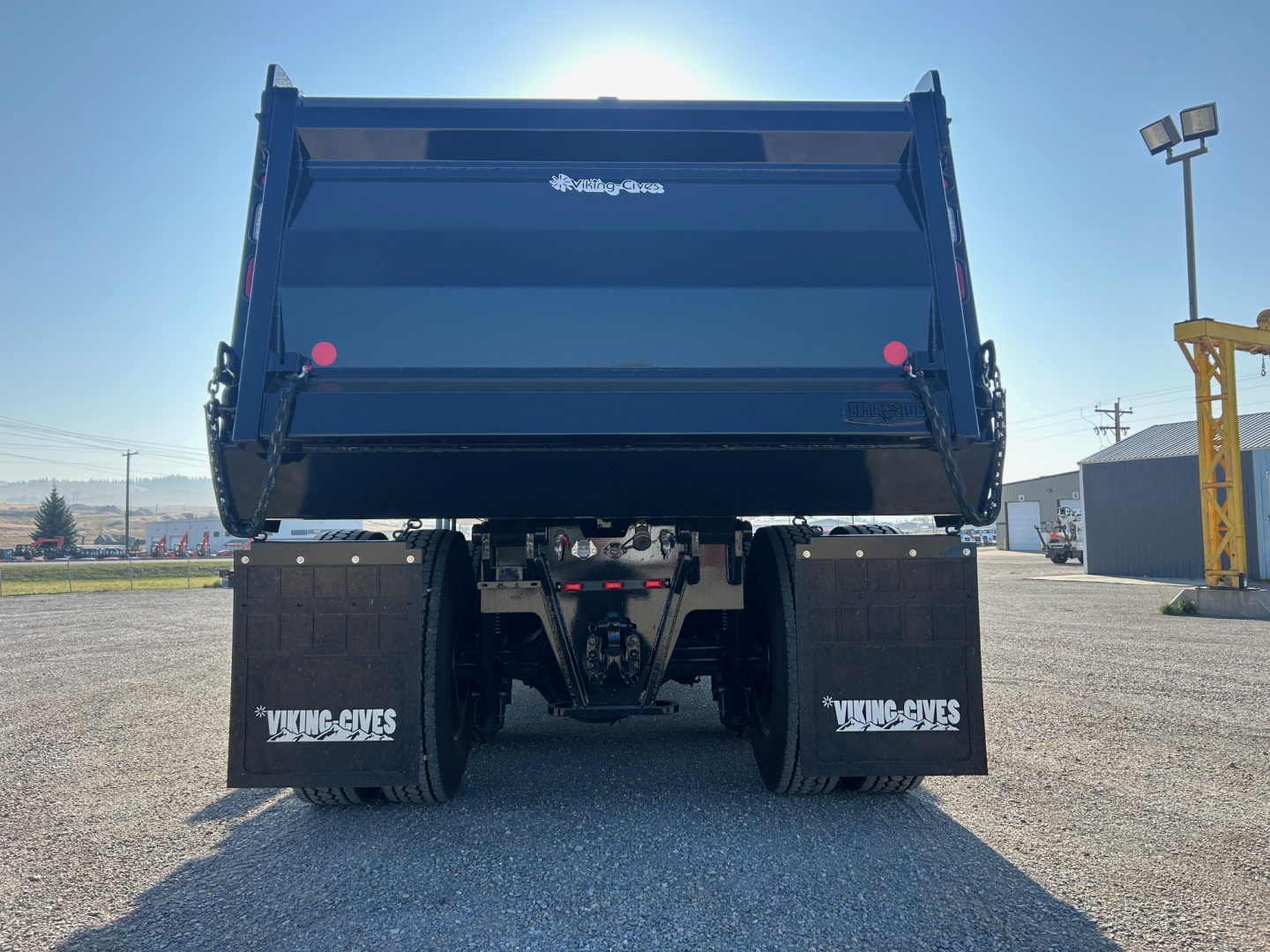 Dump truck bed of a 2025 Volvo VHD84F300 rear view showing dump box and dual rear wheels.