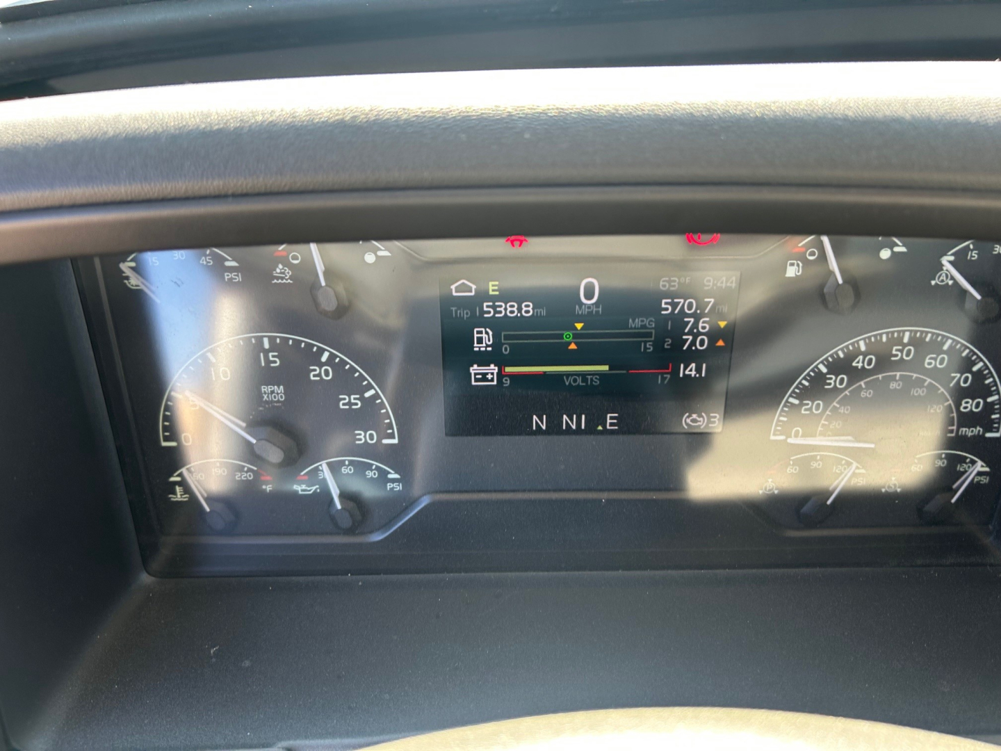 Volvo VHD instrument cluster showing digital display with speed and RPM gauges, fuel level, and warning indicators.