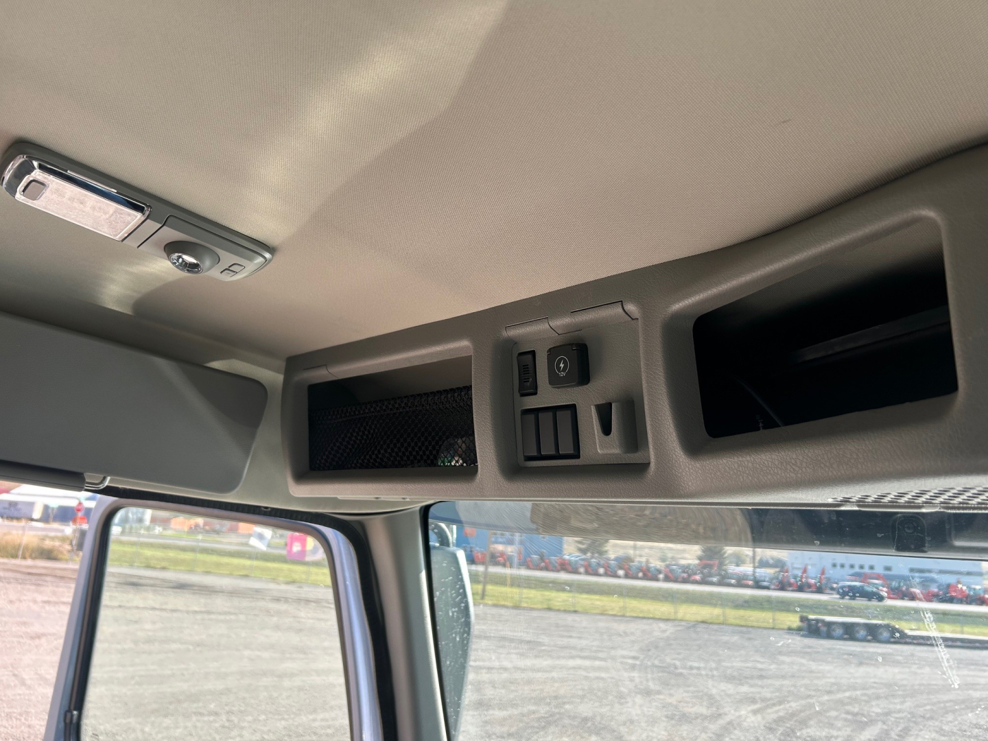 Cab interior overhead console with switches and storage pockets, no visible text or labels readable.