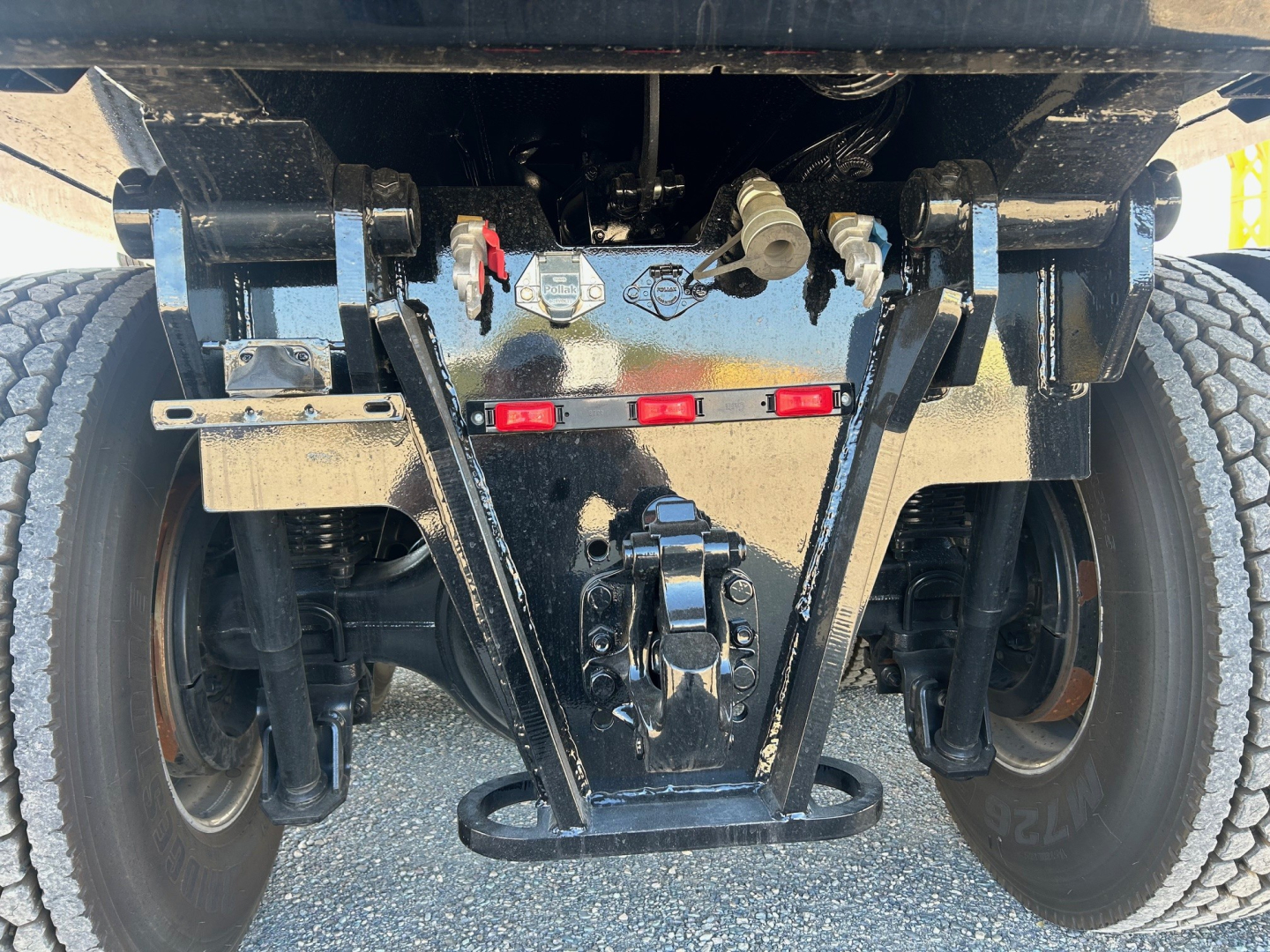 Volvo VHD84F300 truck rear suspension and bumper showing axles, leaf springs, and hitch components.