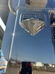 Beau-Roc emblem on blue truck chassis, close-up view of diamond-shaped logo with embossed BEAUROC text