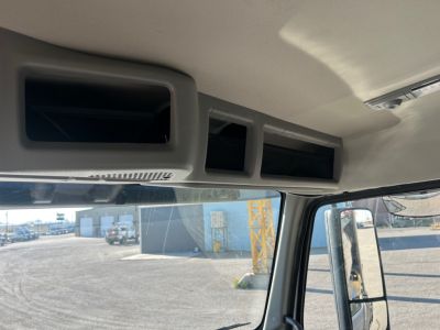 Cab interior ceiling vents and overhead storage openings in a Volvo VHD truck cab.