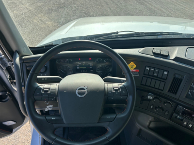 Volvo VHD84F300 truck cab interior showing steering wheel and dashboard with controls and gauges.