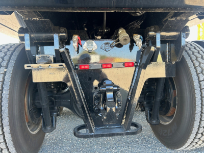 Volvo VHD84F300 truck rear suspension and bumper showing axles, leaf springs, and hitch components.