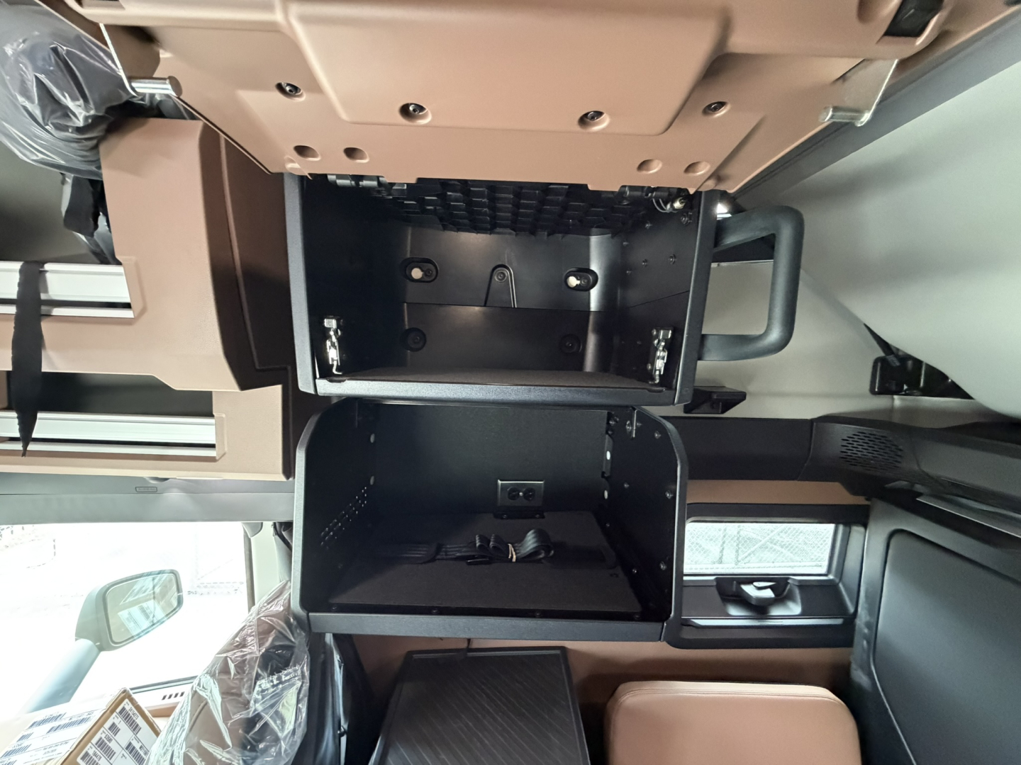 Cab interior of a 2027 Mack PR64T76H showing overhead storage compartments and dashboard area visible in the cab.