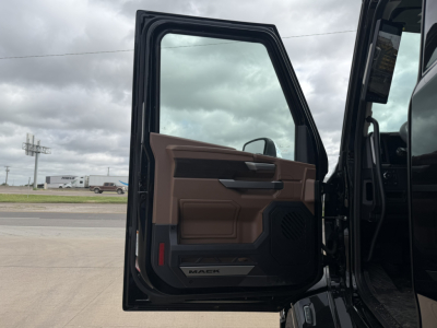 Truck door interior of a new 2027 Mack PR64T76H with brown and black cabin panel, open door showing Walker branding and control panel.