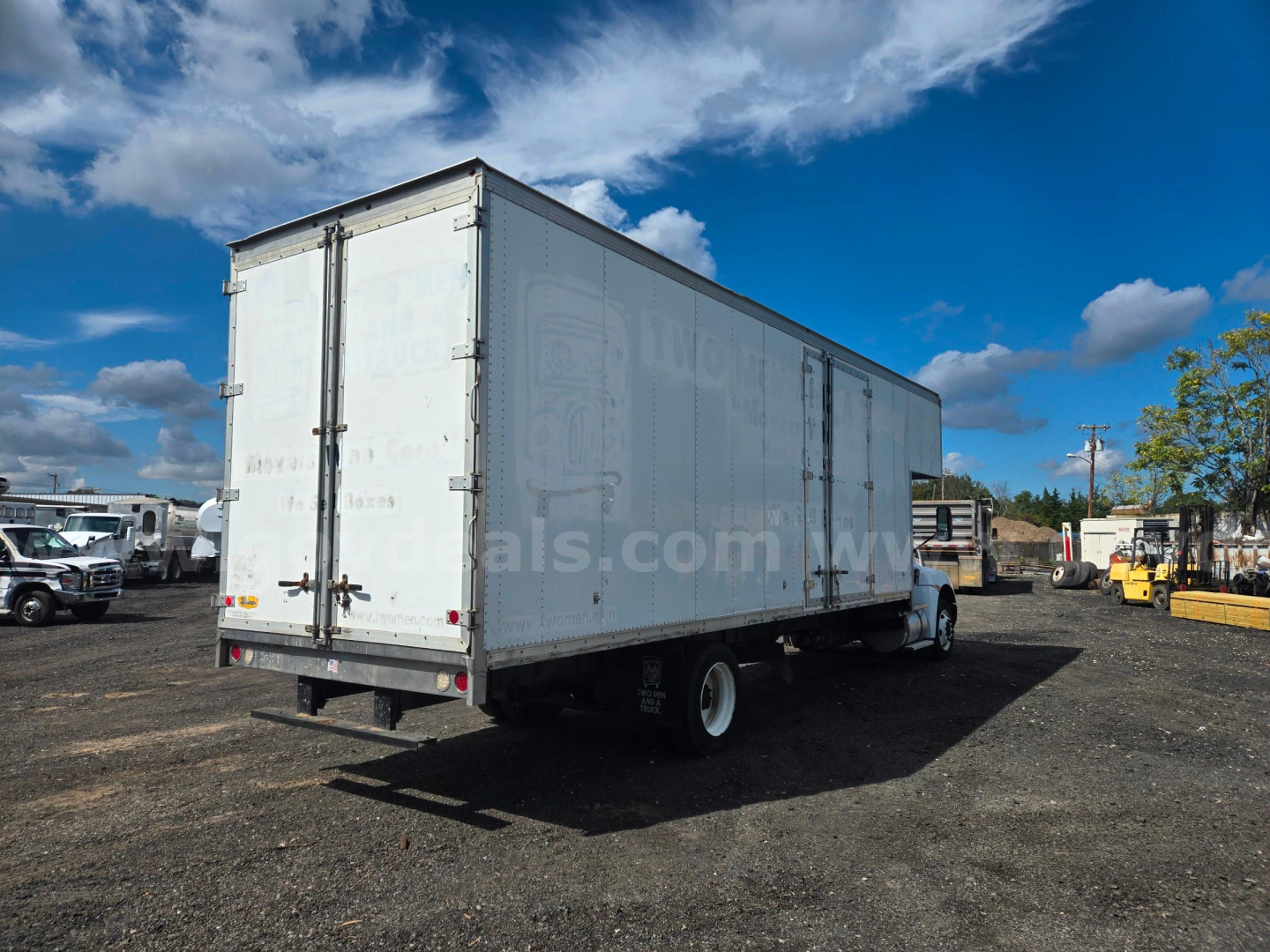 Kenworth box truck rear and side view showing enclosed cargo area and dual rear doors.