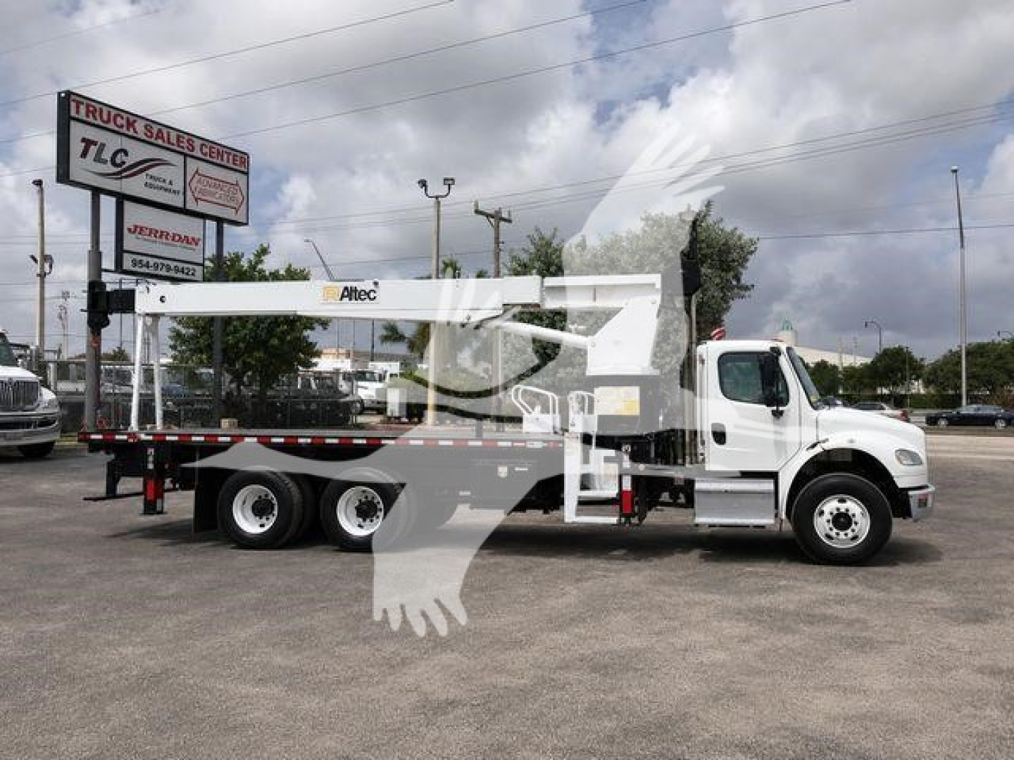 Altec AC18-70B crane mounted on a white heavy-duty truck chassis, side view showing crane boom retracted, stock TD5591, blue sky with clouds.