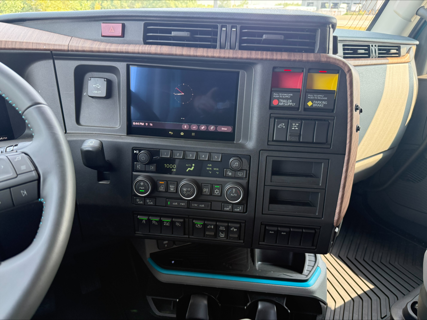 Volvo VNL64T860 truck cab interior showing dashboard touchscreen, control panel, and air vents.