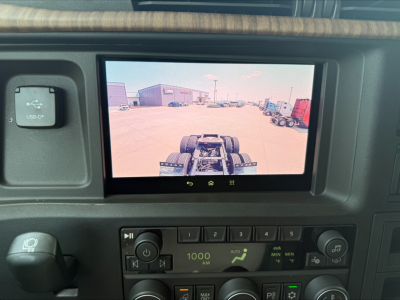 Volvo VNL64T860 dash display showing rear view camera screen with truck cab interior controls in view.