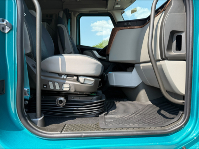 Volvo VNL64T860 truck cab interior showing driver's seat controls and entry area.