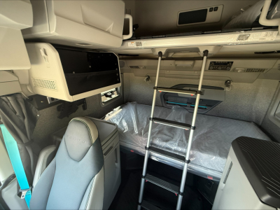 Volvo VNL64T860 cab interior showing bunk bed area and ladder within sleeper compartment.