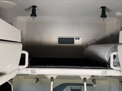 Volvo VNL64T860 sleeper cab interior cargo area showing storage space and a vented duct nearby.
