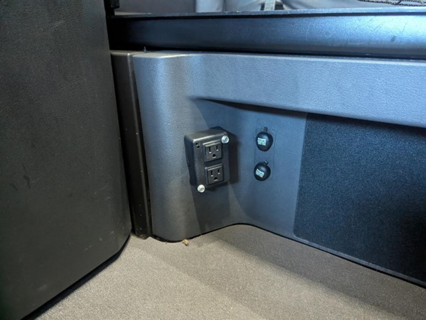 Freightliner Cascadia 126 cab interior showing power inlet and controls in a sleeper area.