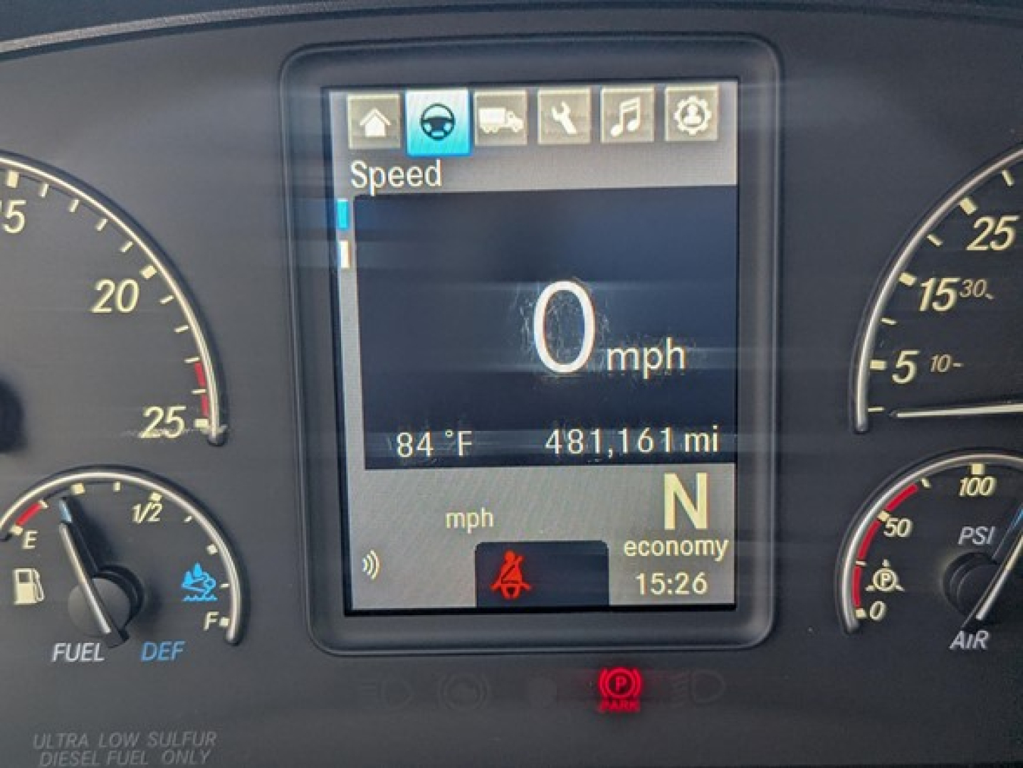 Dashboard display showing speed 0 mph, 84°F, 481,161 miles, N gear, economy mode, time 15:26, with circular gauges on left and right and warning icons.