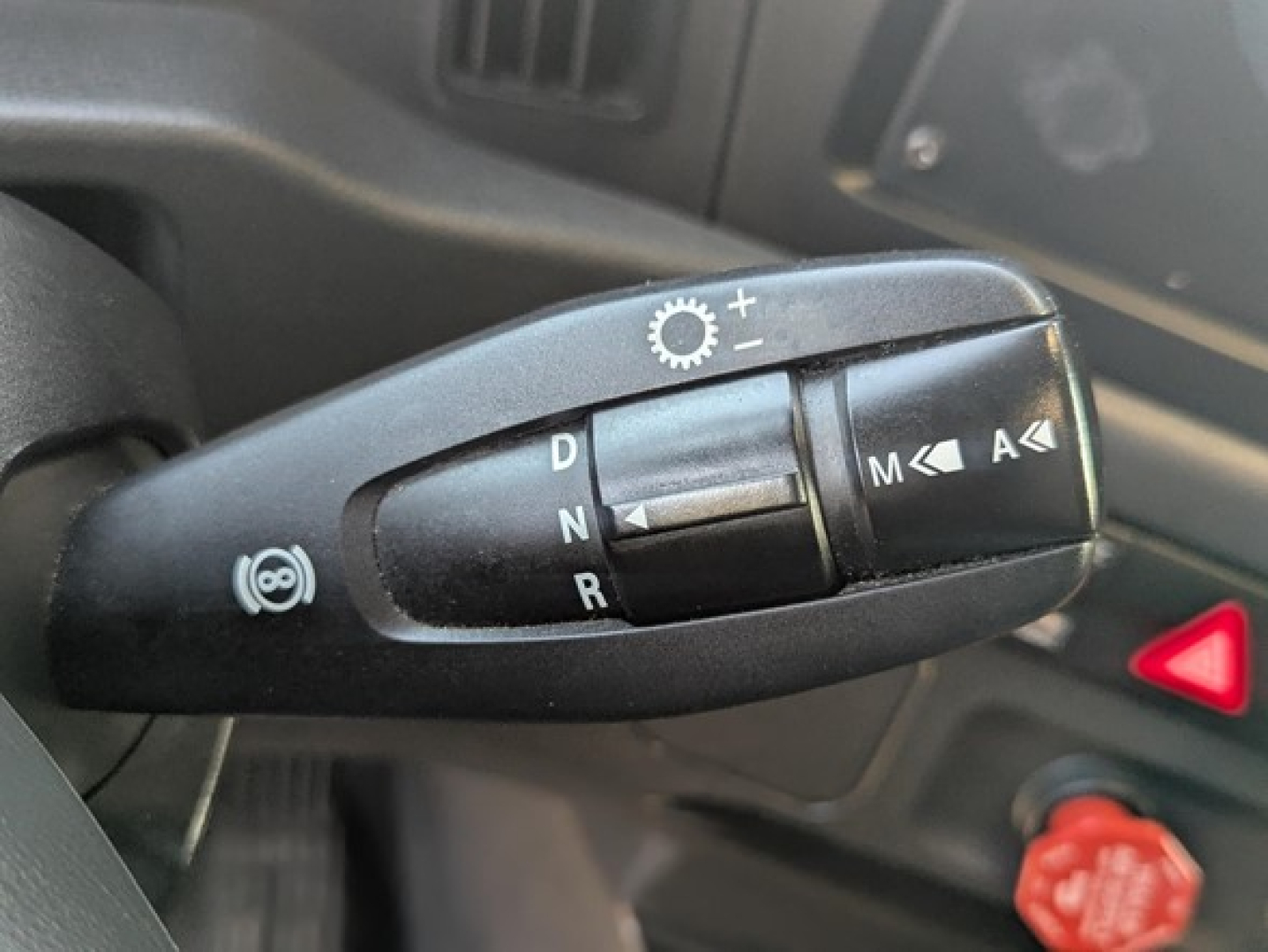 Truck gear shifter stalk with D N R and cruise control symbols in Freightliner Cascadia cabin view