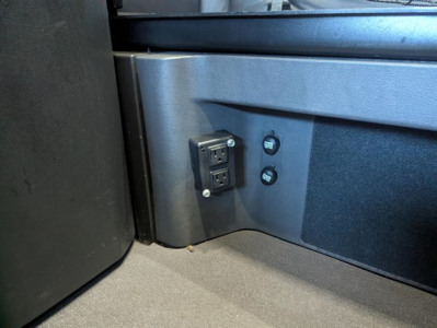 Freightliner Cascadia 126 cab interior showing power inlet and controls in a sleeper area.
