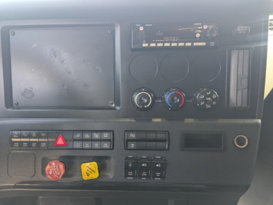 Dashboard of a Freightliner Cascadia 126 truck showing control panel, climate knobs, radio, hazard button, and red and yellow warning switches.
