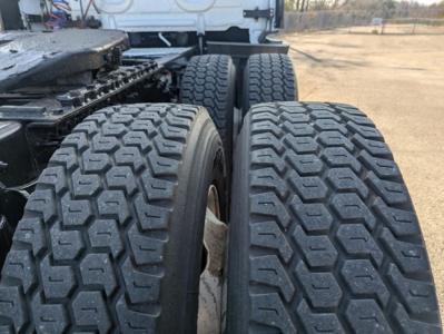 Freightliner Cascadia 126 truck rear wheels showing dual rear axles and tread pattern.