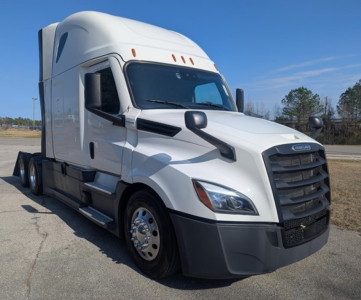 Truck cab in front view showing Freightliner Cascadia 126 with large black grille, white exterior, dual highway mirrors, and sleeper compartment.