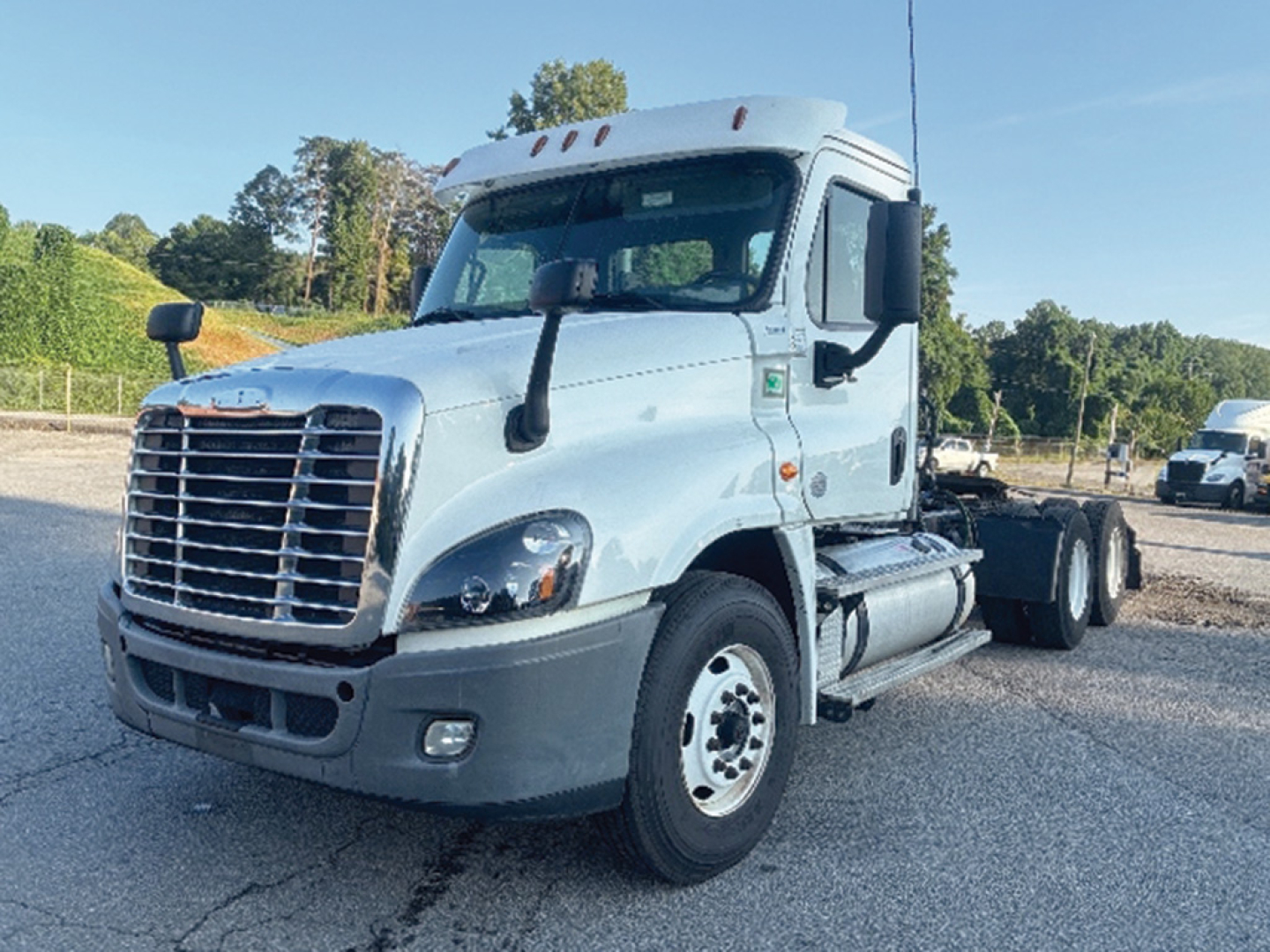 Truck cabin and front chassis of a 2020 Freightliner Cascadia125 daycab, front grille, headlights, and side mirrors visible.