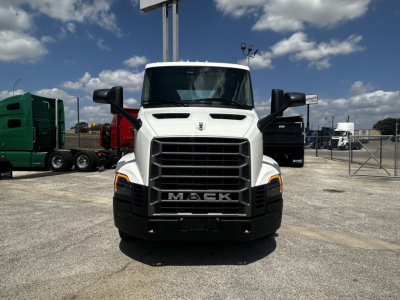 Front view of white 2027 Mack AN64T truck in a dealership lot with other trucks in background.