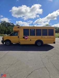 School bus side view showing yellow 2018 Chevrolet Express G4500 mini bus with stop sign and Central School lettering.