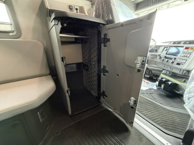 Volvo VNL64T860 truck interior showing open cabinet with shelves and small storage space inside the cab